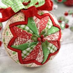 a red and green ornament with bows on it