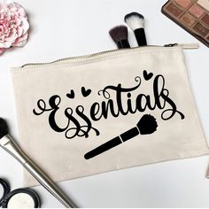 a makeup bag with the words essentials written on it next to cosmetics and brushes