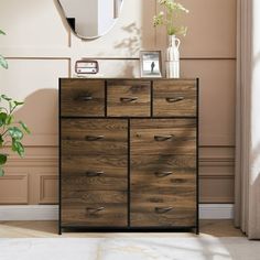 a wooden dresser sitting in front of a mirror