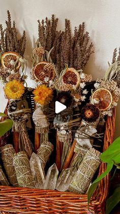 a wicker basket with dried flowers in it