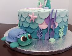 there is a cake decorated with sea animals on the table