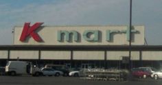 cars are parked in front of a kmart store