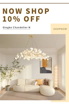 a living room with white furniture and a chandelier hanging from the ceiling that says now shop 10 % off