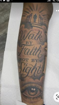 a man's arm with an eye and words on it that says work by faith not by sight