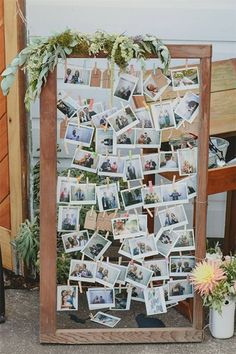 a wooden frame filled with photos and flowers