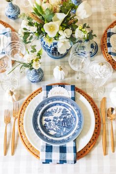 a blue and white table setting with flowers