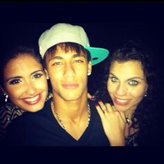 three people are posing for a photo with one woman and the other man wearing a hat