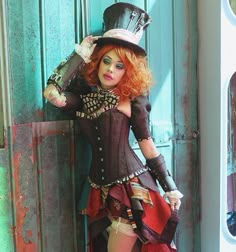 a woman dressed in steampunk clothing posing for the camera