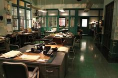 an old fashioned office with many desks and chairs in the middle of the room