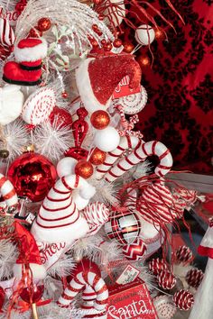 a christmas tree decorated with candy canes, ornaments and other holiday decorating items