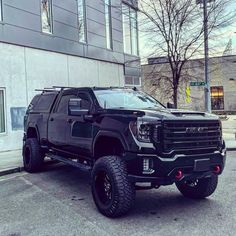 a black truck parked in front of a building