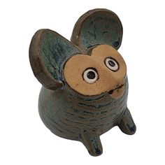 a ceramic figurine of a mouse with eyes on it's head and nose