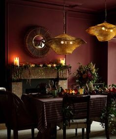 the dining room is decorated with candles and greenery