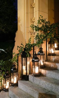 several lit up lanterns sitting on the steps