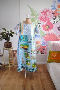 a dress on a mannequin in front of a floral wallpaper