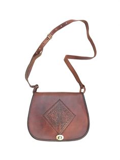 Magnificent handbag in genuine full grain leather engraved in the center. Turnstile clasp. . It has a long, adjustable leather strap that allows it to be worn over the shoulder. Color: Camel brown. Measurements: 21.5 x 18.5 cm. Brown Leather Engraved Shoulder Bag, Bohemian Brown Rectangular Saddle Bag, Luxury Brown Vegetable-tanned Leather Saddle Bag, Artisan Hand-tooled Leather Saddle Bag, Bohemian Leather Shoulder Bag With Hand-stitched Details, Leather Engraved, Leather Engraving, Genuine Leather Handbag, Leather Handbag