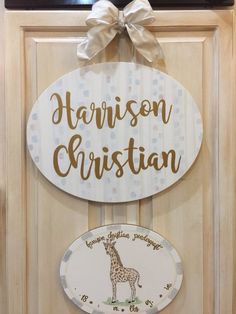 a wooden sign that says harrison christian and a giraffe plaque hanging on the front door