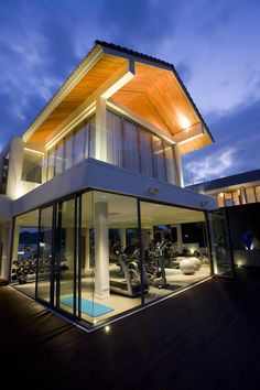 a modern house that is lit up at night