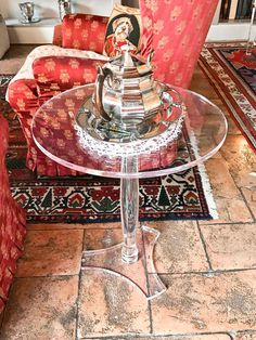 a glass table sitting on top of a tiled floor