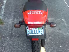 a red and black motorcycle parked in a parking lot