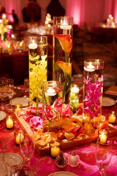 the centerpieces are filled with flowers and candles