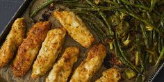 chicken and asparagus on a baking sheet