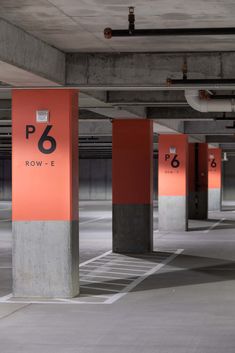 an empty parking garage filled with lots of red and black signs that read p6 row e