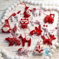 red and white ornaments are arranged on a table