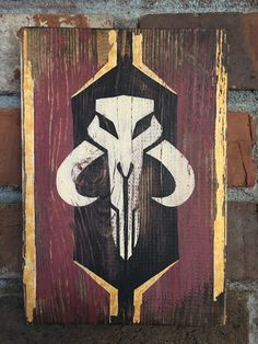 a wooden sign with an animal skull painted on it