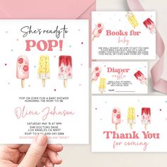 a hand holding up a pink and white card with popsicles on it