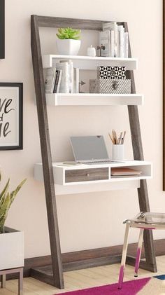 a white desk with a laptop on top of it next to a ladder book shelf