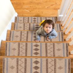 a toddler is crawling down the stairs