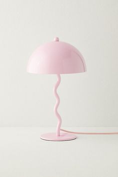 a pink table lamp on a white surface