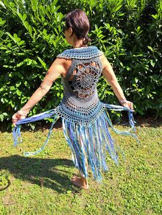 crocheted FESTIVAL VEST size XS-M Fantastic crochet vest with a floral pattern on the back and ties for lacing on the front - therefore adjustable and stretchable from XS-M (32-40), crocheted with love from soft cotton yarn.  Decorated with many long fringes made of different wool, effect yarns, fabrics and lace, which come into their own when walking, dancing and turning. The waistcoat can easily be machine washed at 30oC (possibly gather the fringes with a rubber band beforehand so that they d Fitted Bohemian Blue Vest, Bohemian Fitted Vest For Beach, Blue Sleeveless Vest For Festival, Hippie Style Fitted Sleeveless Vest, Sleeveless Stretch Crochet Top For Festivals, Fitted Sleeveless Hippie Vest, Fitted Bohemian Crochet Vest, Bohemian Fitted Vest For Festival, Fitted Bohemian Vest For Festivals