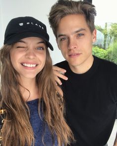 a young man and woman posing for a photo