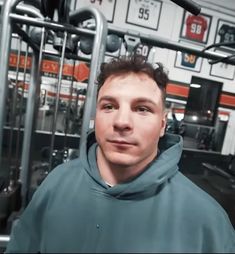 a man standing in front of a gym machine