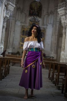 a woman wearing a purple and blue dress in a church