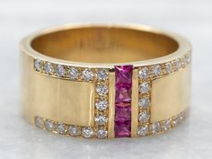 Treat yourself to a stunning piece of jewelry - this beautiful yellow gold wide band sparkles with twinkling rubies and diamonds! Perfect for special occasions or adding a touch of glitz to everyday looks. A dazzling way to show yourself some love!Metal: 18K Yellow GoldGem: 4 Rubies totaling .28 CaratsGem Measurements: 1.5 x 2.6 mm, Emerald Cut Accents: 30 Diamonds totaling .36 Carats, VS-SI in Clarity, F-G in ColorRing Size: 8 *Please note, this band will fit tight due to the width.Marks: "CARELLE 750" Stamped on the inside band Gold Bands For Women, Thick Gold Band, Rubies And Diamonds, Show Yourself, Ruby Diamond, Wide Bands, Emerald Cut, Gold Bands, Twinkle Twinkle