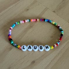 Brand New, Handmade Bright, Colorful Beaded Bracelet With The Word Laugh On Round Disc Beads. Multiple Bracelets Available. Each Bracelet Is Full Of Many Color Beads And Each Is Unique. Bead Order Is Completely Different, Will Not Look Exactly Like The One Pictured Above. Please Make Sure You Agree With This Before Ordering Bracelet Is Made With A Strong, Stretch Cording For Easy On And Off. To Make Your Bracelet Last Longer Slide Carefully On Your Wrist And Don’t Purposely Yank Or Pull On To St Red Letter Beads For Friendship, Fun Red Beaded Bracelet, Colorful Beaded Chain Bracelets As Gift, Fun Beaded Bracelets With Round Beads, Multicolor Beaded Chain Friendship Bracelets As Gift, Multicolor Beaded Chain Friendship Bracelet For Gift, Multicolor Beaded Chain Friendship Bracelet, Swift Concert, Multiple Bracelets