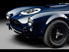 an old blue sports car with numbers on it