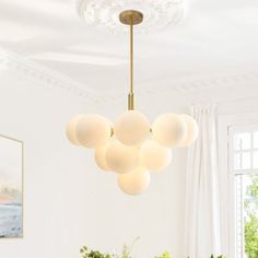 a dining room table and chairs with a chandelier hanging from it's ceiling