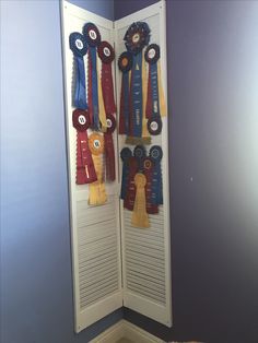 a room divider with ribbons hanging on it's sides in front of a blue wall