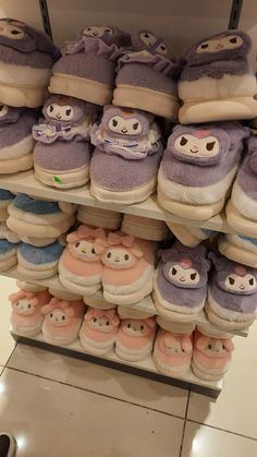 there are many pairs of slippers on the shelf in the store and one pair is for sale