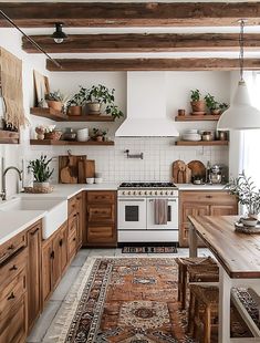 a kitchen with wooden cabinets, white appliances and lots of plants on the shelves above the stove