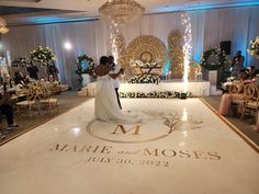 a bride and groom standing on the dance floor