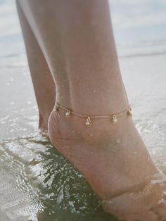 14 karat gold plated anklet featuring tiny shells with pearl beads. Choose your preferred length from the box. Gold Anklets With Beads For Summer, Gold Anklets With Tiny Beads As Gift, Gold Anklets With Pearl Charm As Gift, Gold Anklets With Pearl Charm For Gift, Gold Beaded Anklets For Beach, Dainty Gold Anklets With Pearl Chain, Gold Dainty Anklets With Pearl Charm, Dainty Gold Anklets With Pearl Charm, Gold Anklets With Tiny Beads For Beach