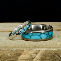 two wedding rings with turquoise stones on them