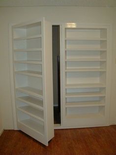 an empty room with two open white shelves