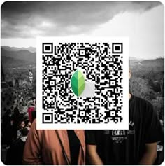 two people standing next to each other with a qr code on their face in front of them