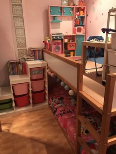 there is a bunk bed in the corner of this room with pink walls and wooden flooring